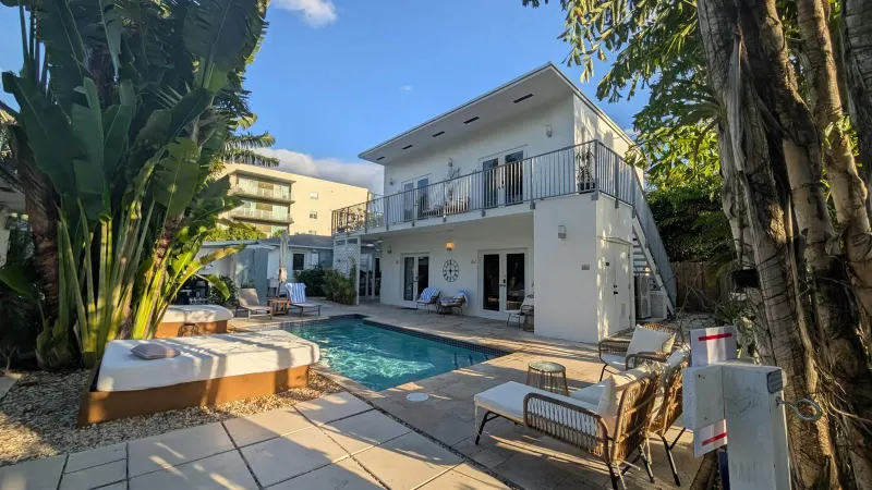 Pool, daybeds and the two-storey guest building
