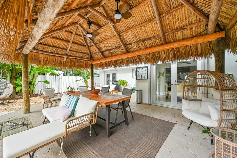 Shaded tiki lounge with dining table